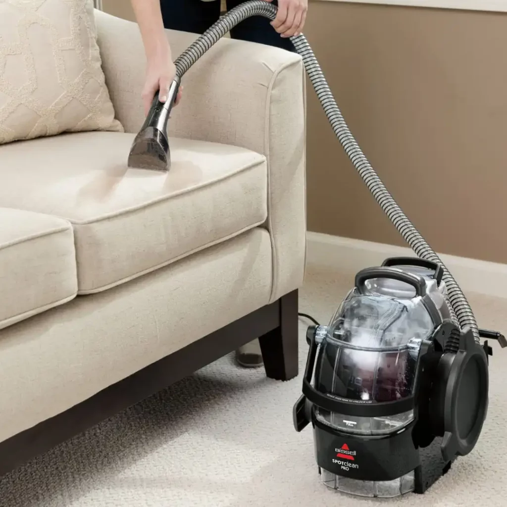 vacuuming a sofa