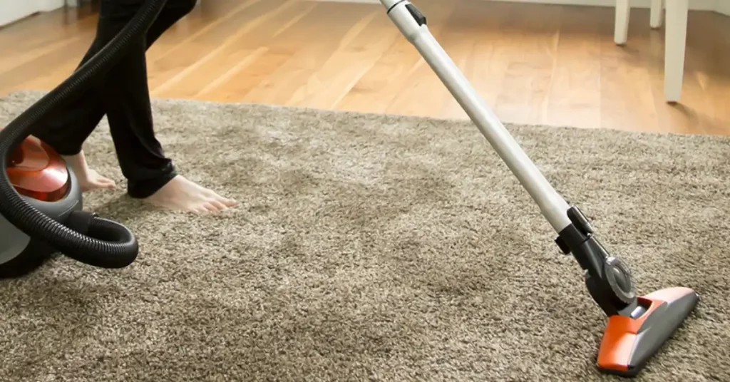 vacuuming a carpet