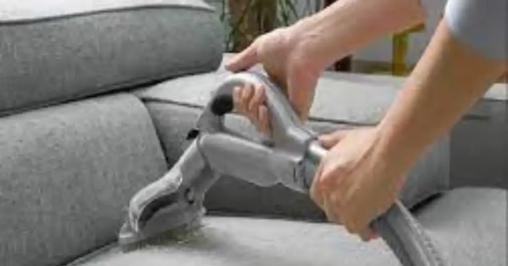 vacuuming a sofa